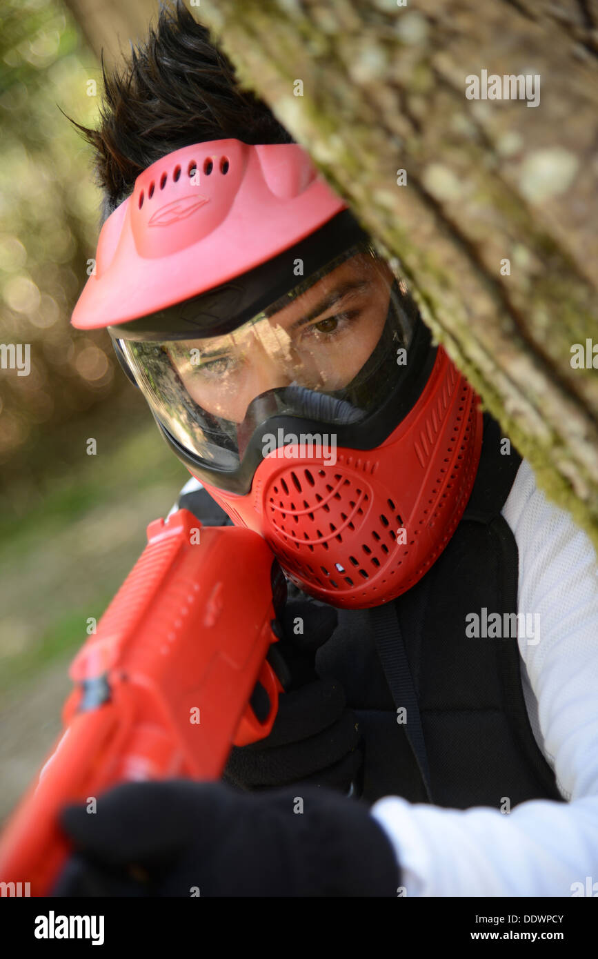 Young children playing paintball in the woods Stock Photo Alamy