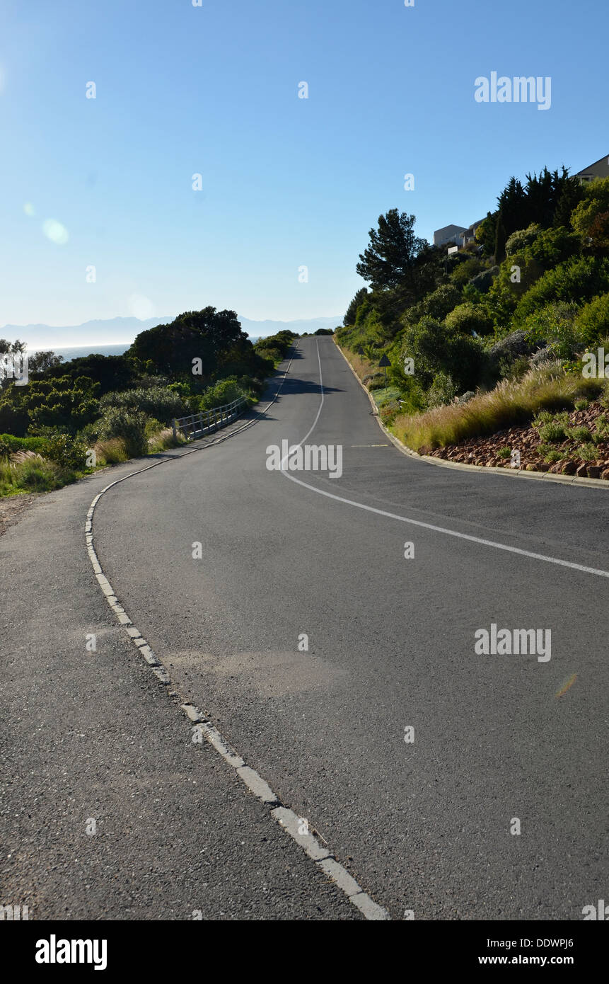 Country road disappearing into distance with center line and verge Stock Photo