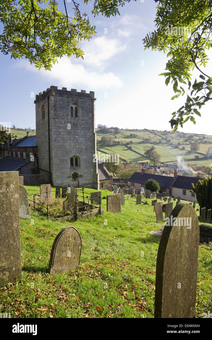 Village churchyard with rolling countryside in the background. Brassington, Derbyshire, UK. Stock Photo