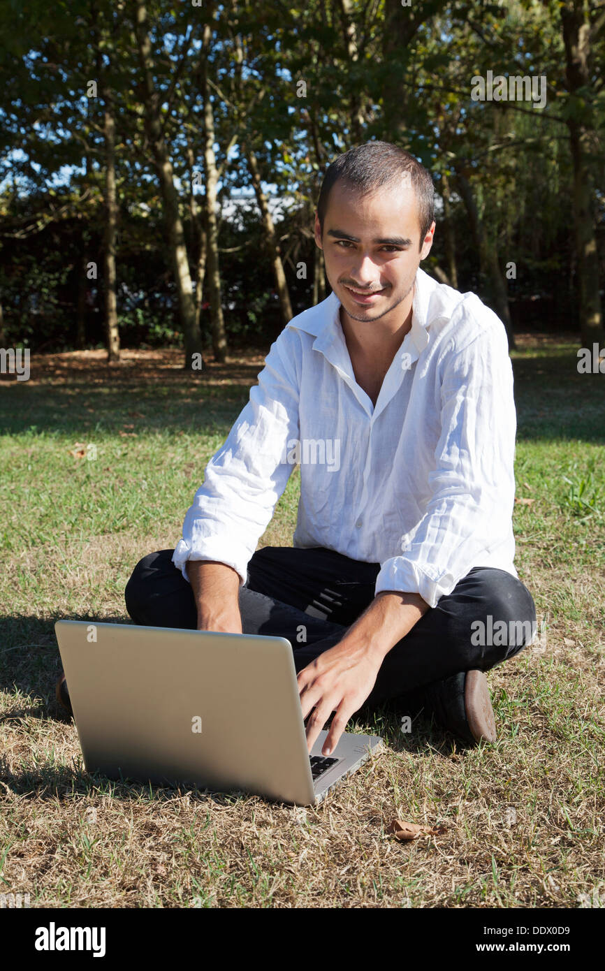 young boy on computer outdoor Stock Photo