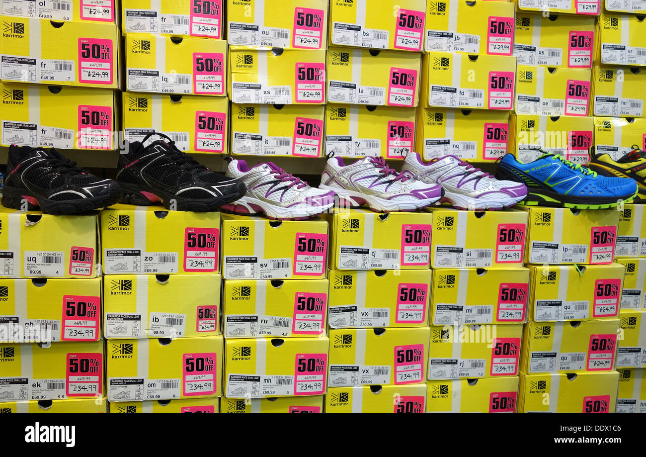 Trainers on sale in a Sports Direct store Stock Photo