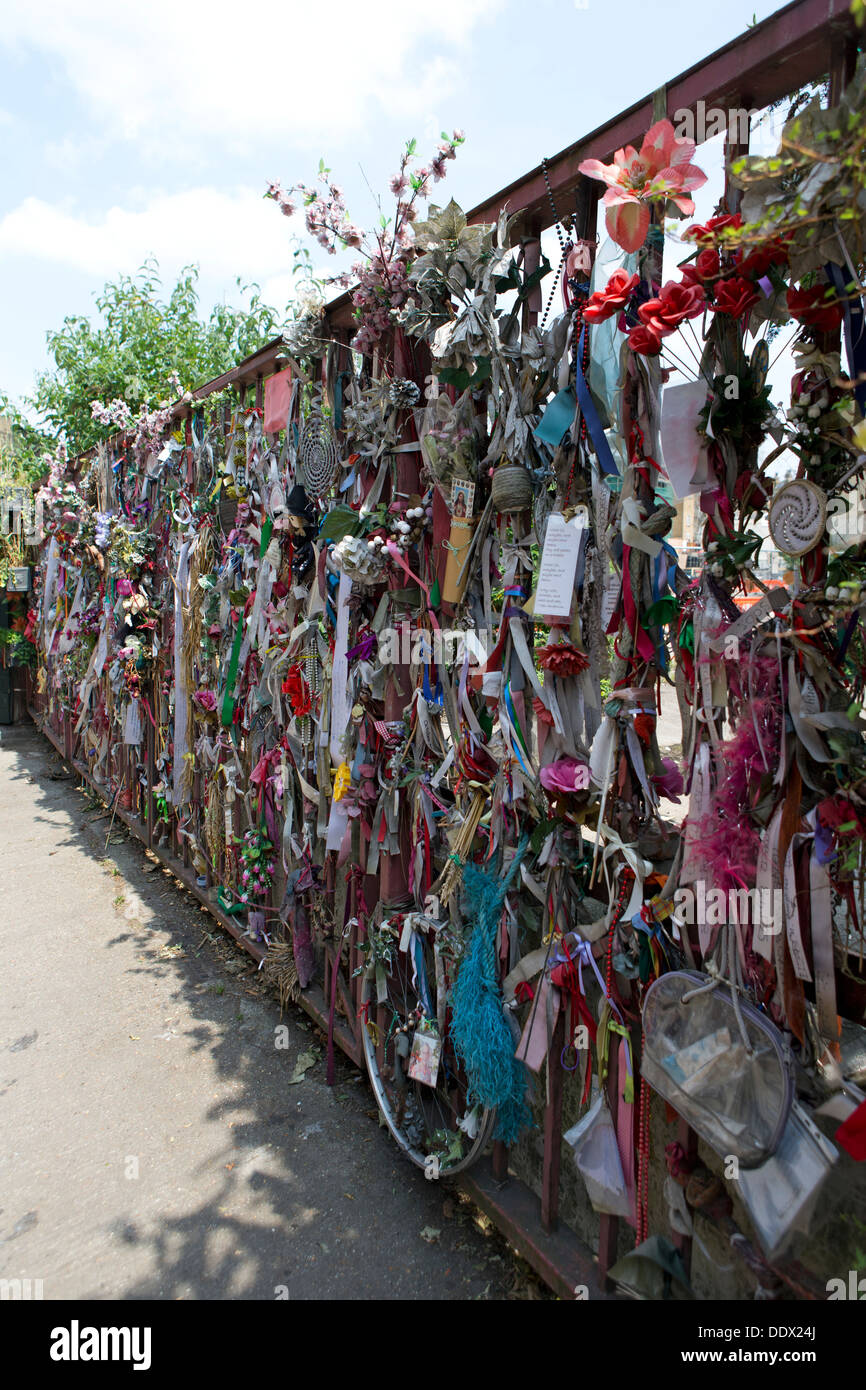 Flowers & Ribbons draped on the gates near Cross Bones Graveyard, Redcross Way, Southwark, London, England, UK. Stock Photo