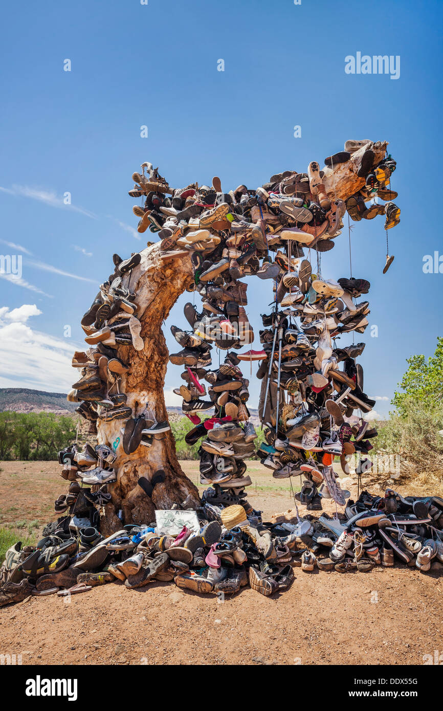 Tree trunk covered in shoes from travelers passing by, Virgin, Utah Stock Photo