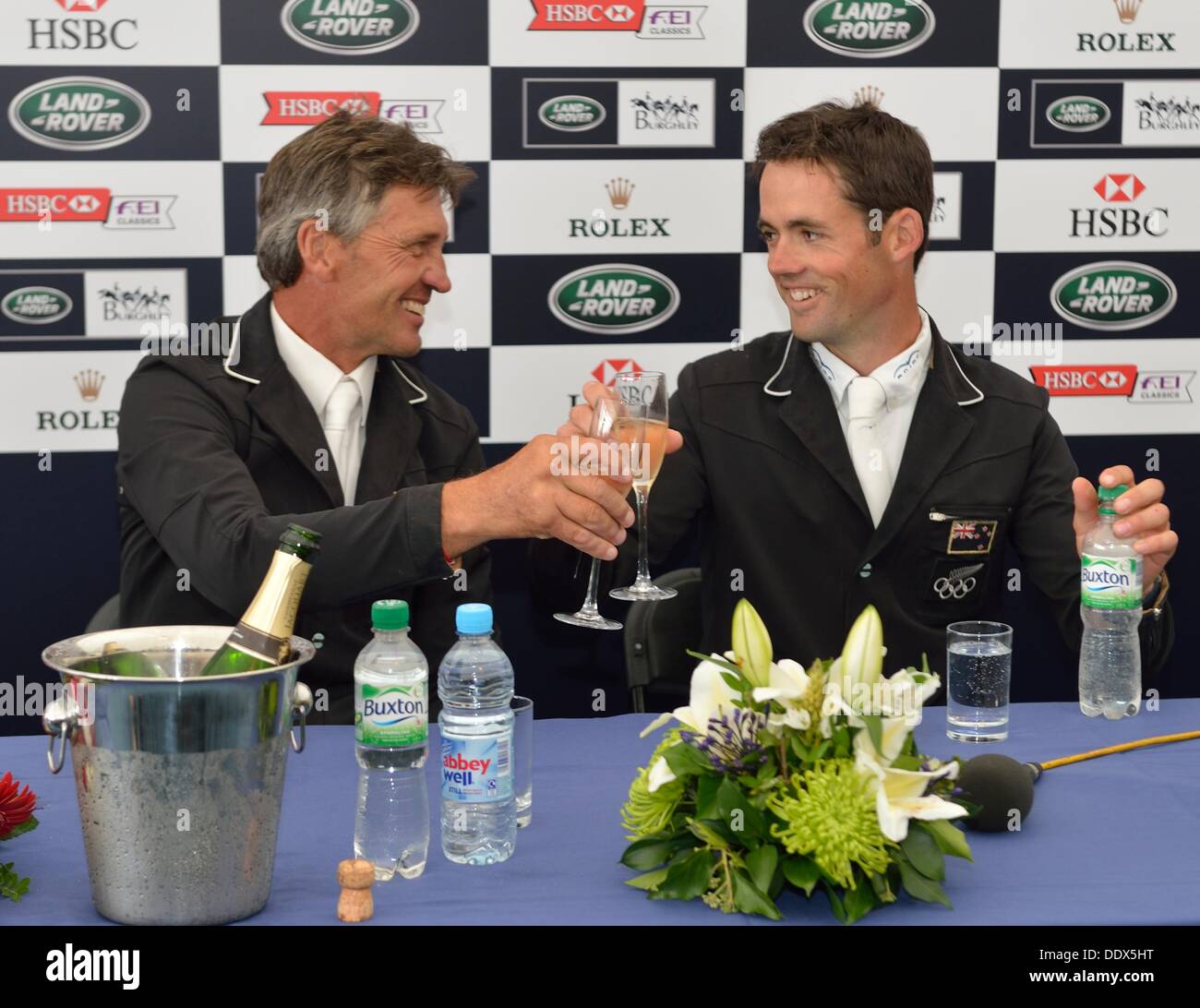 Stamford, UK. 8th Sep, 2013. Andrew Nicholson [NZL] toasts Jonathan Paget [NZL] on winning The 2013 Land Rover Burghley Horse Trials.  Jonathan Paget followed up his win at Badminton earlier in the year with a second four start event win riding the same horse, CLIFTON PROMISE. The combination won the event on a total score of 41.1.  The Land Rover Burghley Horse Trials take place between 5th - 8th September at Burghley House, Stamford.  Credit:  Stephen Bartholomew/Alamy Live News Stock Photo