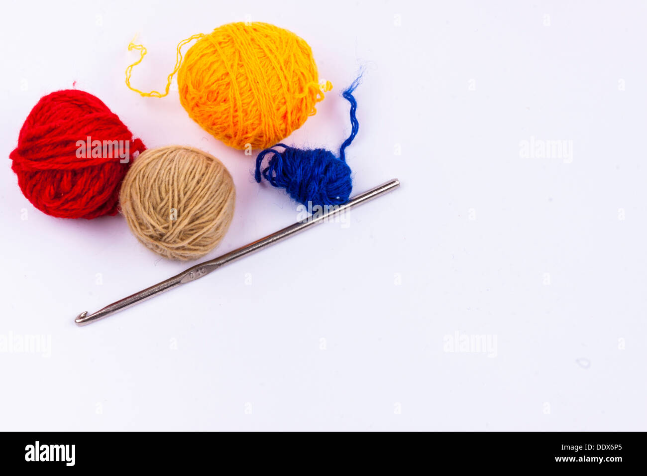 Crochet hook and wool on white background Stock Photo - Alamy