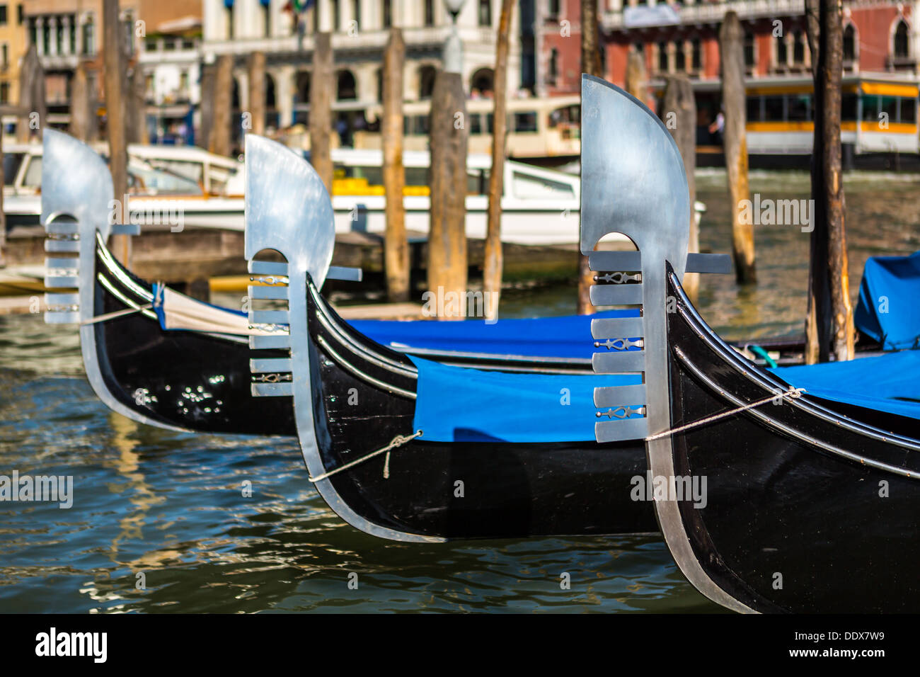 Three venetian gondolas moored on a water street in Venice, Italy Stock Photo