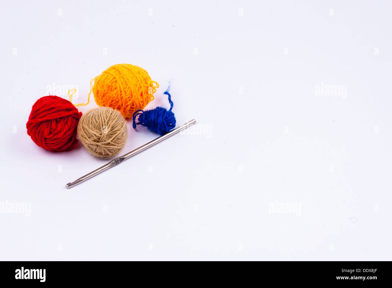 Crochet hook and wool on white background Stock Photo Alamy