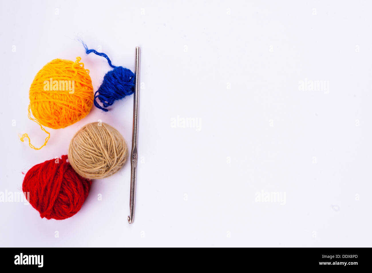 Crochet hook and wool on white background Stock Photo - Alamy