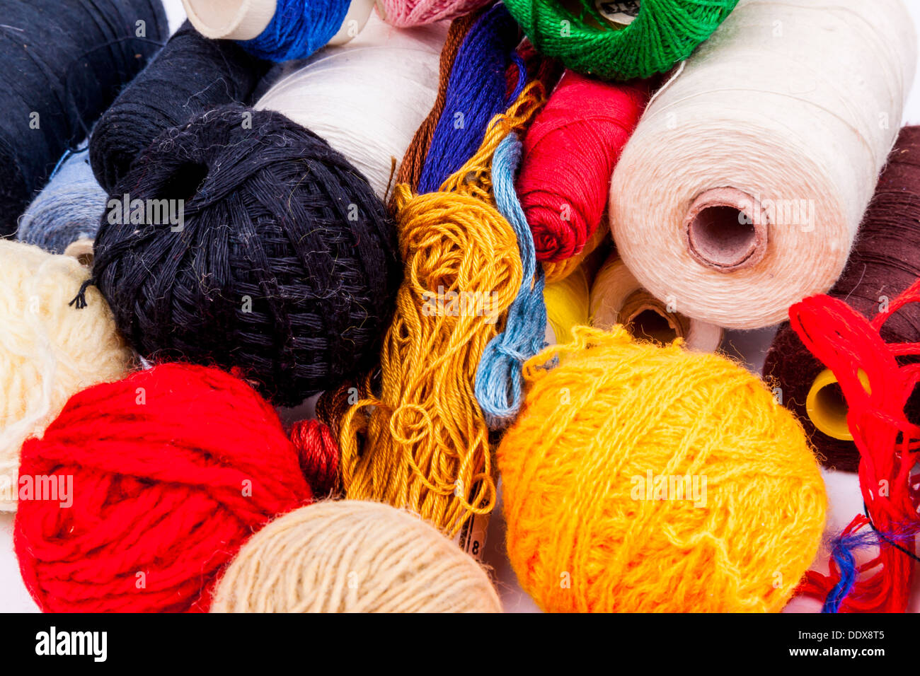 Colourful threads and wool on white background Stock Photo - Alamy