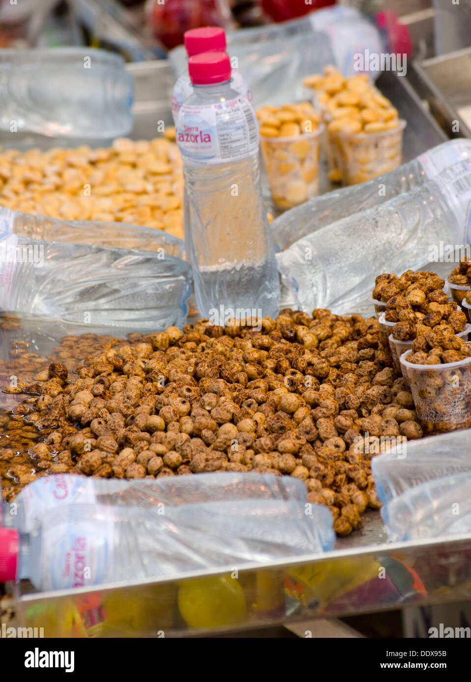 Roasted chick peas and habas beans or white lupin beans and plastic water bottles. Mijas in Southern Spain. Costa del Sol. Stock Photo