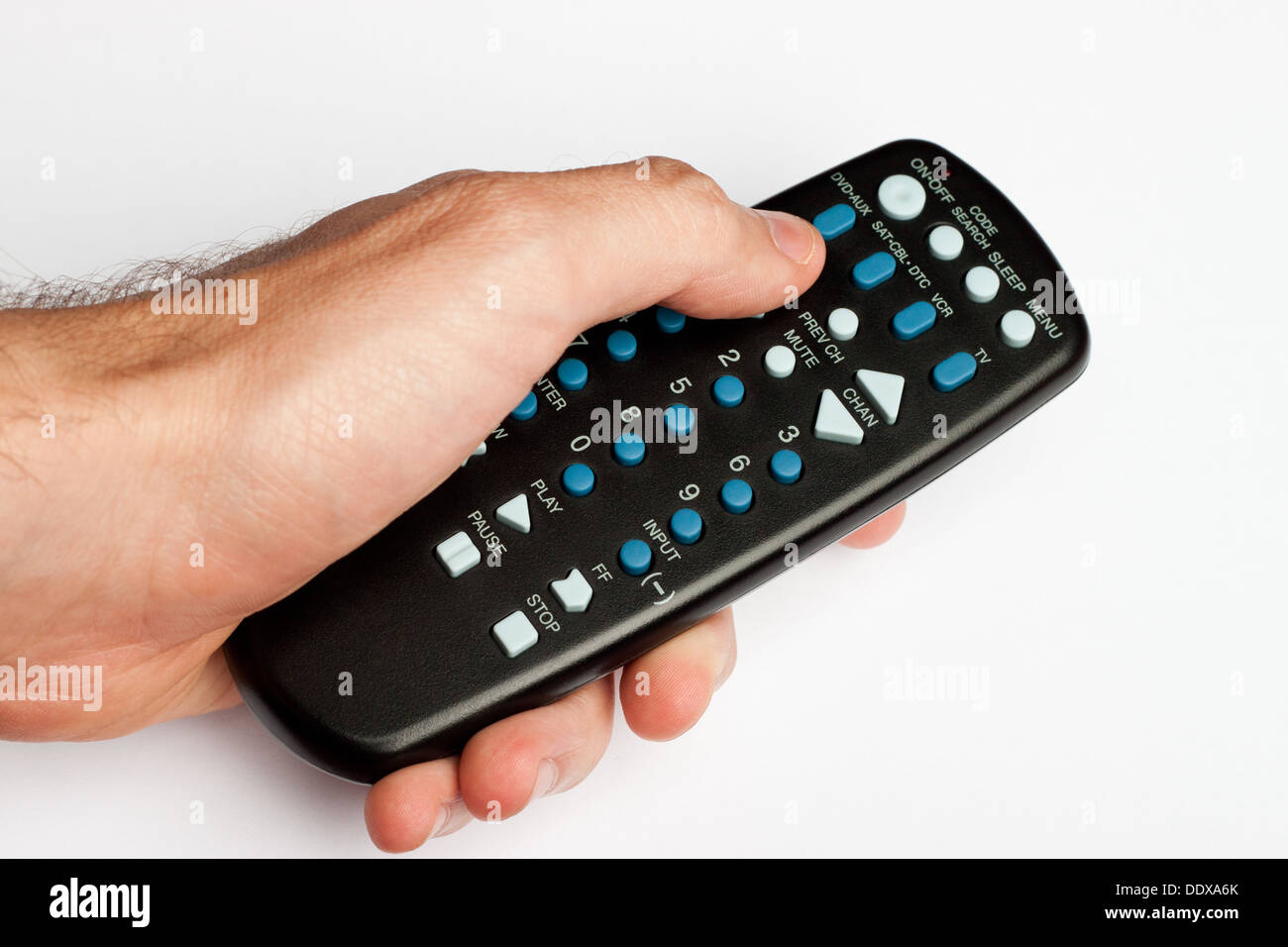 Hand holding a black TV remote Stock Photo