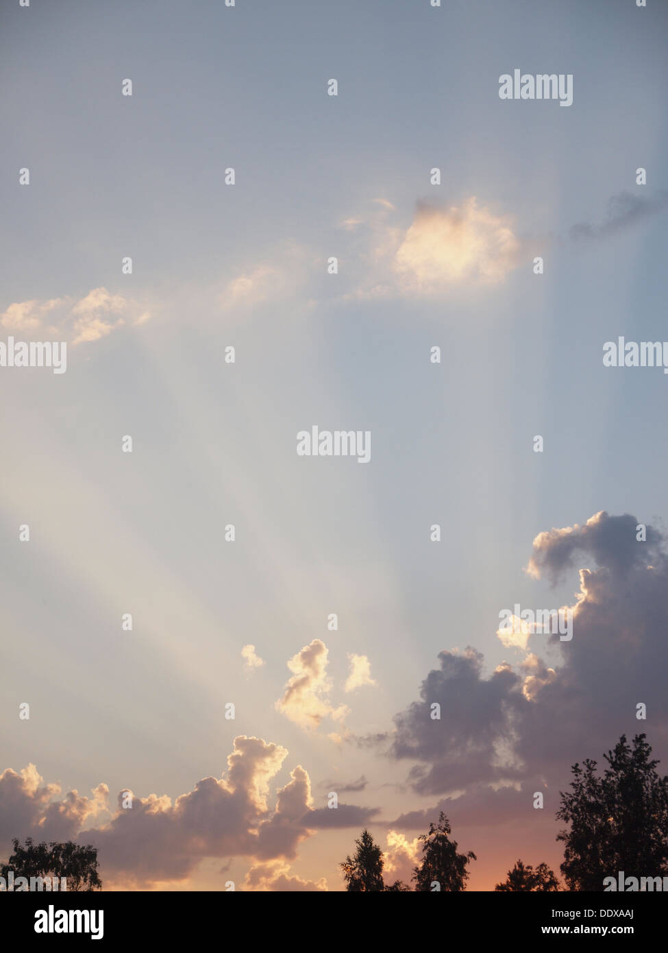 Beams of the sun make the way through clouds Stock Photo - Alamy