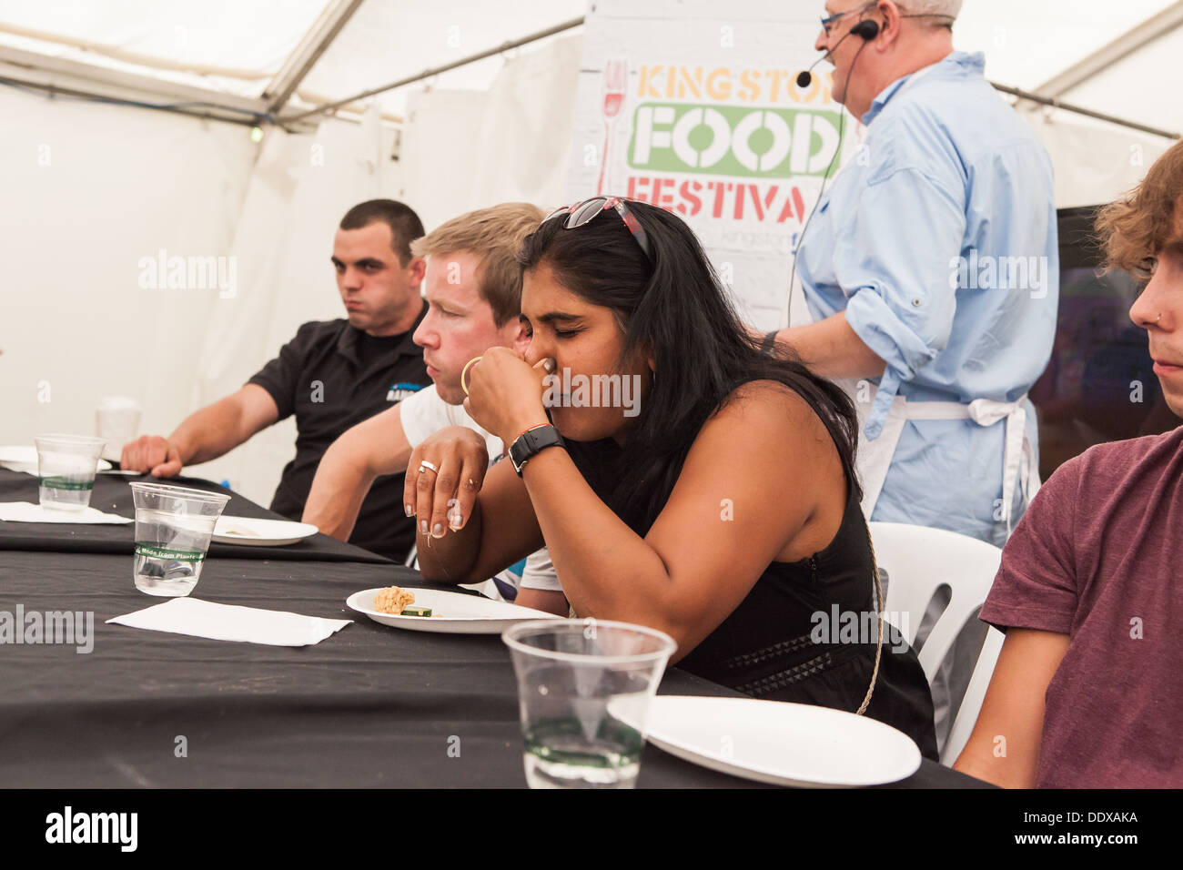 Extreme Food Challenge Kingston 2013 - a contestant is suffering as she forces down dishes  considered delicacies by some. Stock Photo