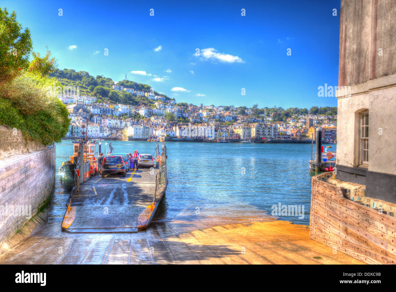 Car ferry at Kingswear Devon view of Dartmouth with brilliant blue sky and white cloud in HDR Stock Photo