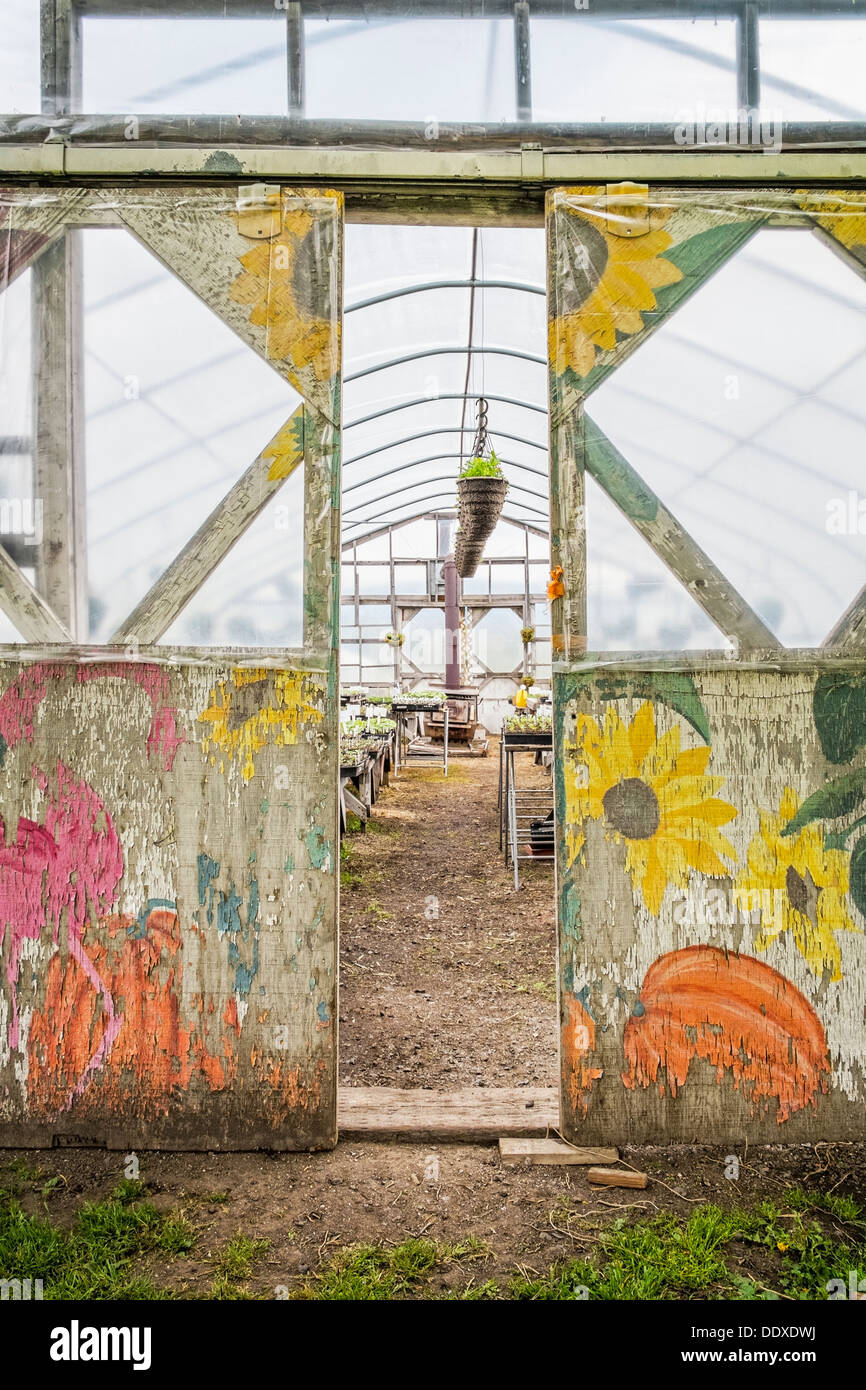 Doorway of greenhouse painted with vegetables and flowers, Oregon Stock Photo