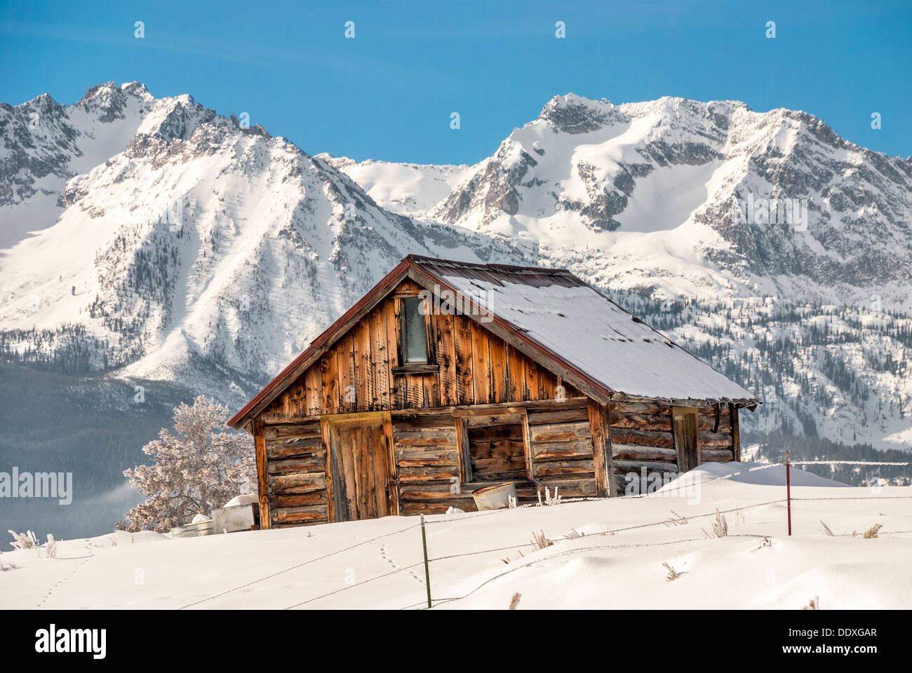 Snowy cold mountains with a wooden log cabin Stock Photo - Alamy