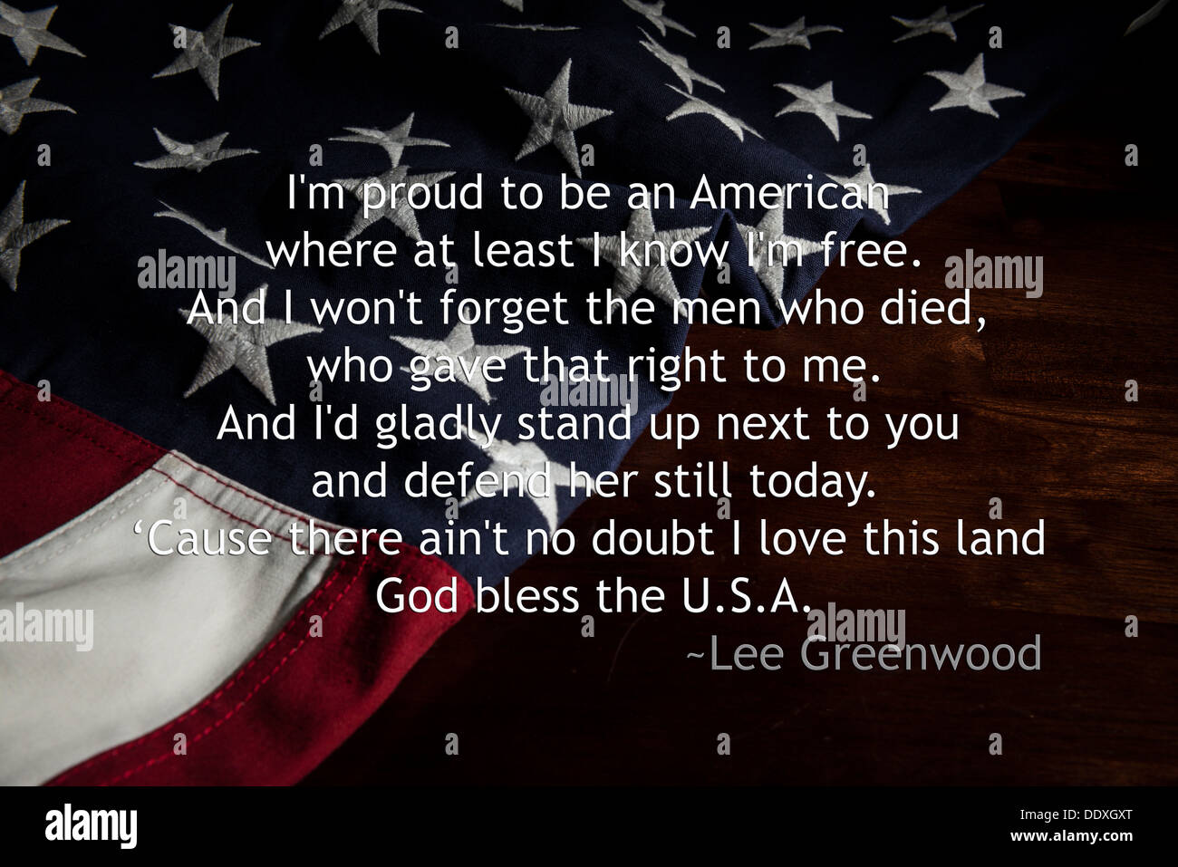 Proud to be an American - lyrics from Lee Greenwood song over an American  flag Stock Photo - Alamy