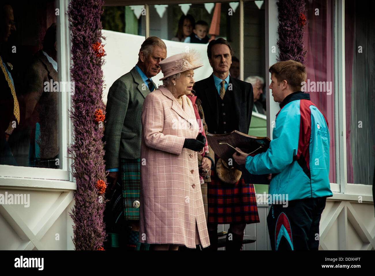 Braemar, Scotland, United Kingdom. September 7th, 2013: H.M. The Queen awards the winner in the relay race  during the annual Braemer Highland Games at The Princess Royal and Duke of Fife Memorial Park Stock Photo