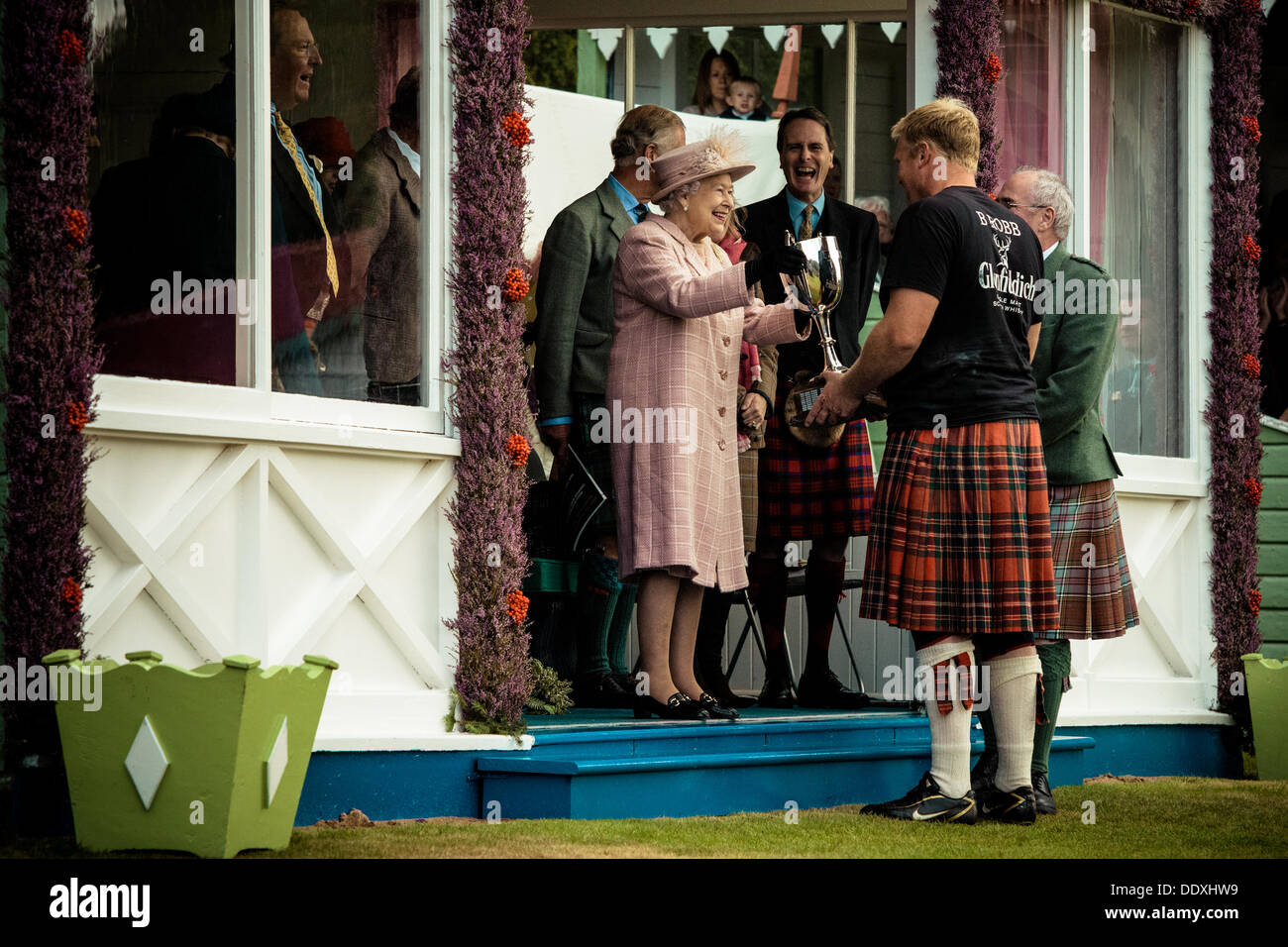 Braemar, Scotland, United Kingdom. September 7th, 2013: H.M. The Queen awards the winner in the heavy weight competition  during the annual Braemer Highland Games at The Princess Royal and Duke of Fife Memorial Park Stock Photo