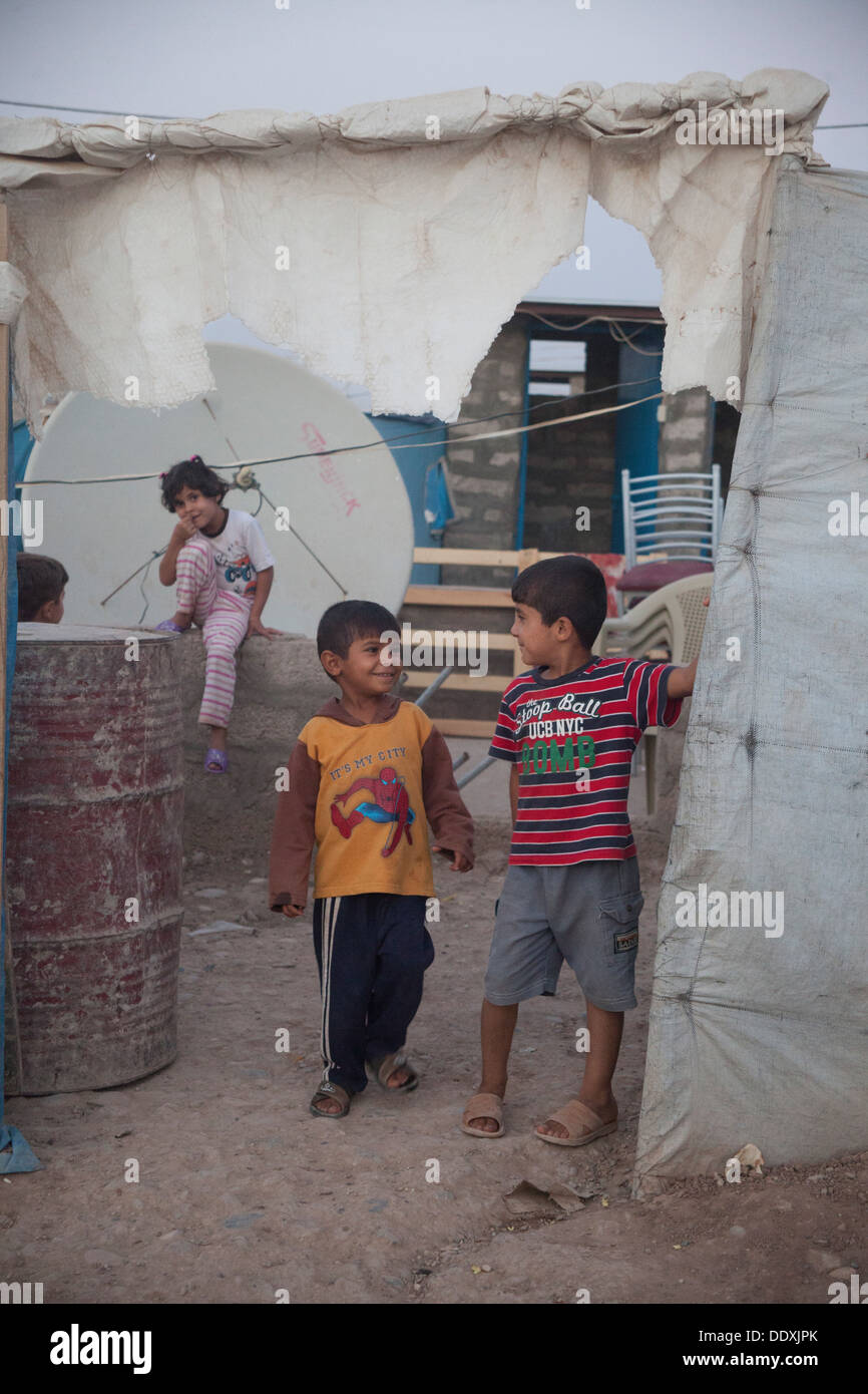 - Northern Iraq (Iraqi Kurdistan) - Domiz Refugees Camp Children coming out from an emergency house Stock Photo