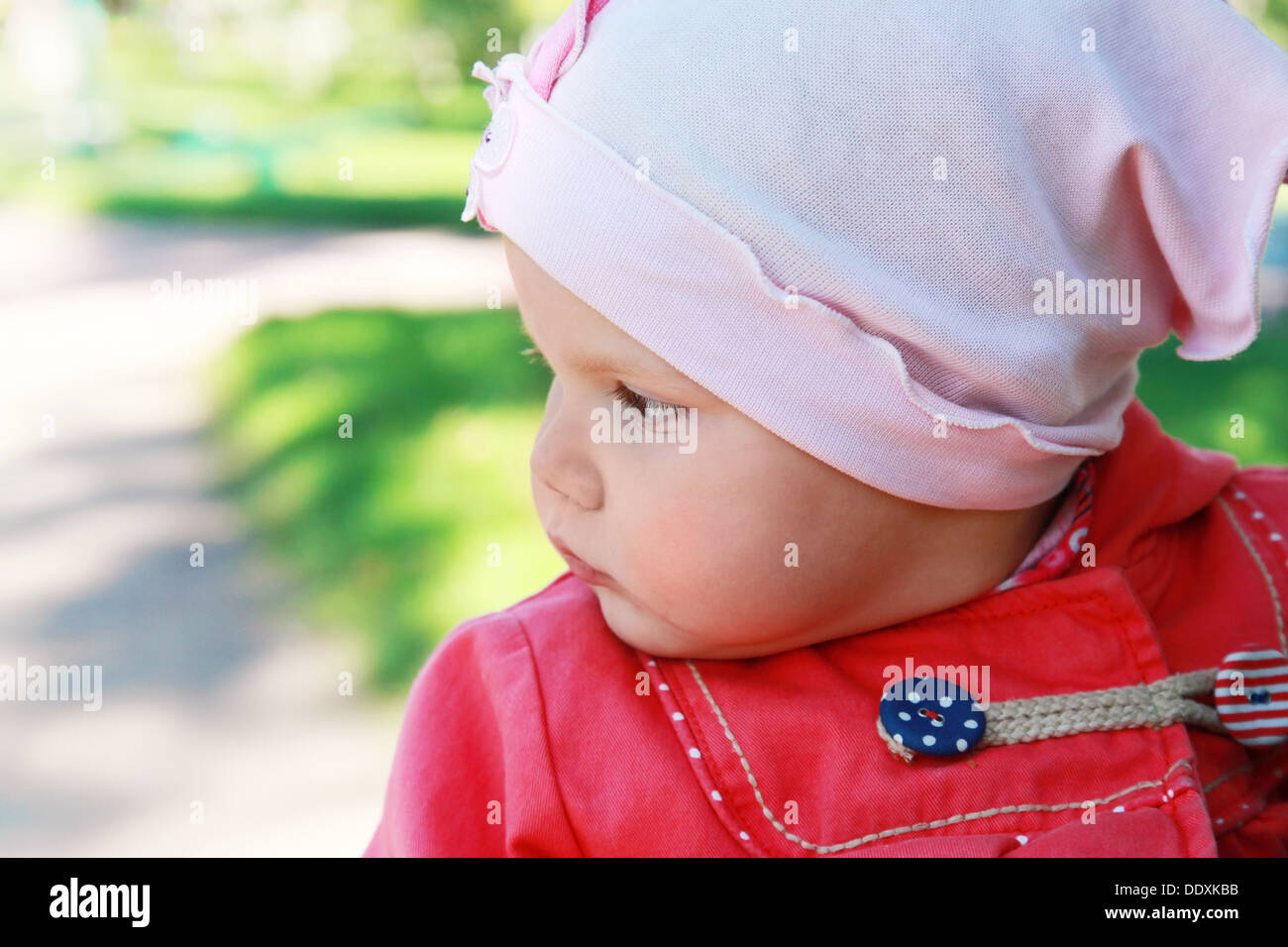 Little baby girl in the park, closeup portrait Stock Photo