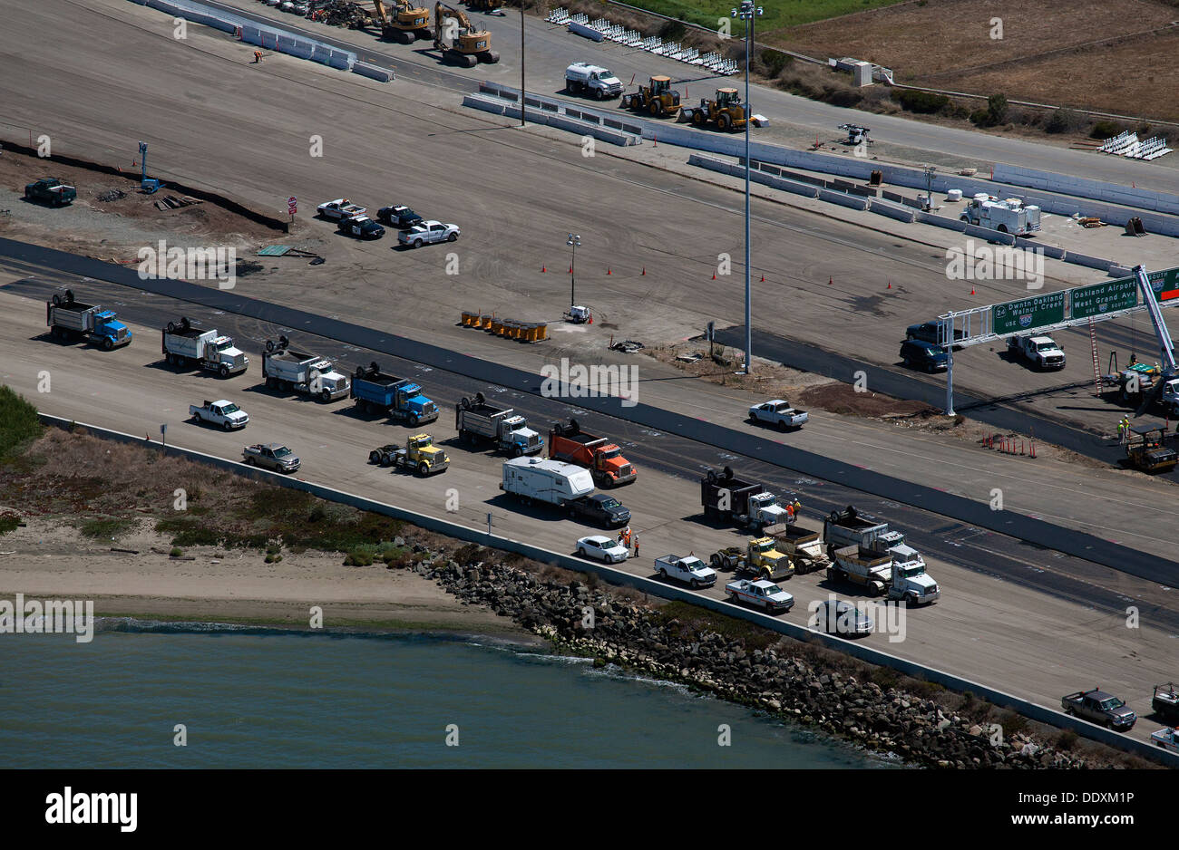 aerial photograph dump trucks during construction San Francisco Oakland Bay Bridge Stock Photo