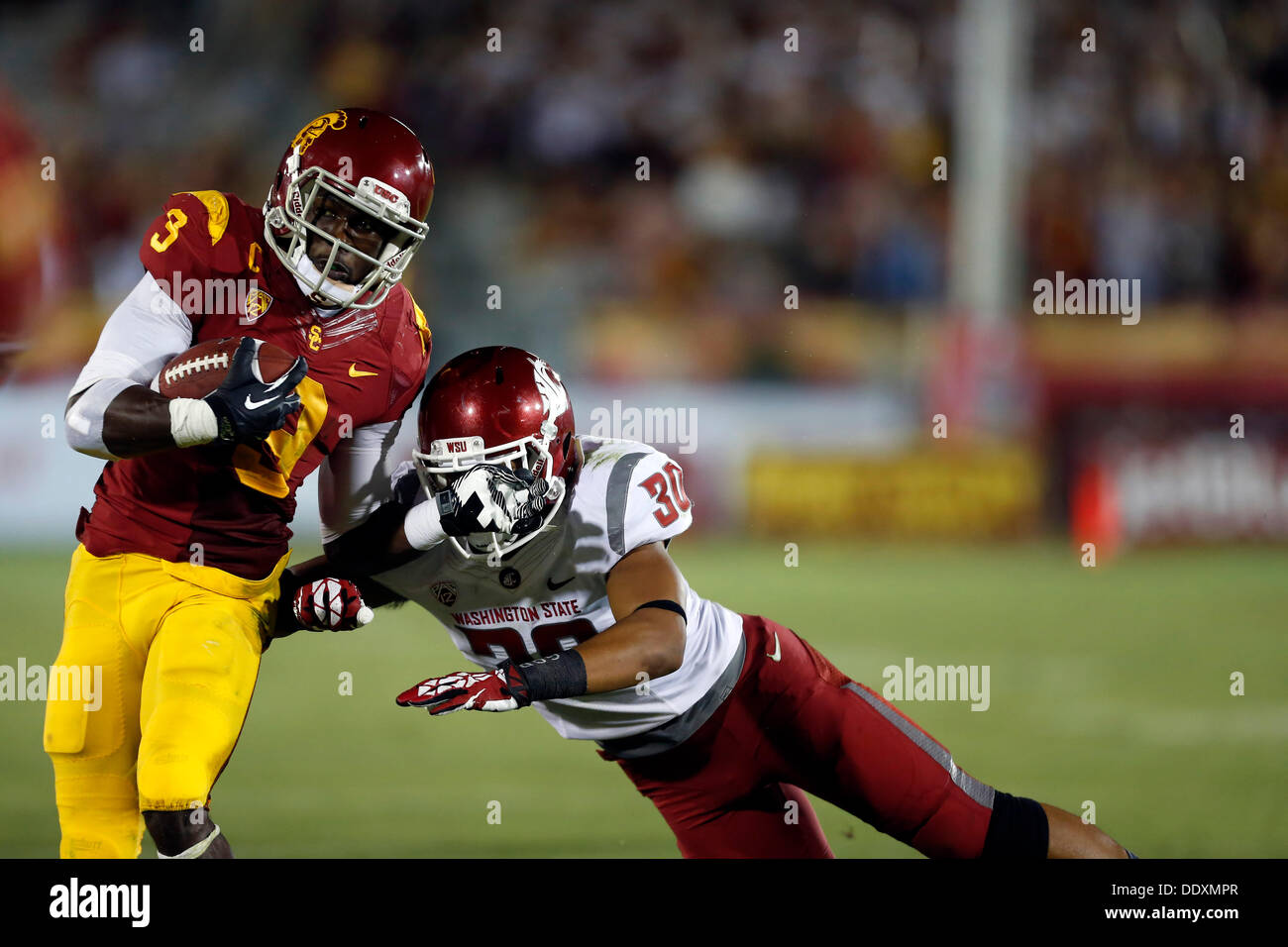 Los Angeles, USA. 7th Sep, 2013. USC Trojans wide receiver Marqise Lee #9  carries the ball and is tackled by Washington State Cougars safety Taylor  Taliulu #30 during the NCAA Football game