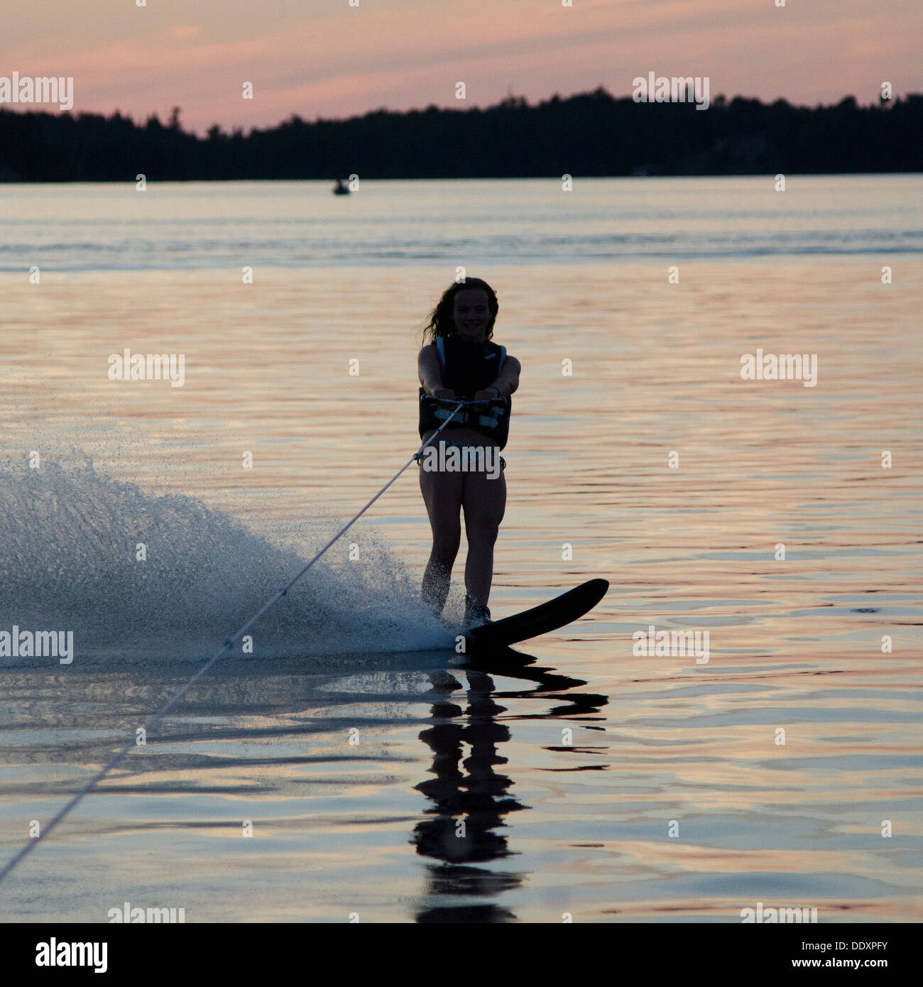 Girl water skiing in a lake, Lake of The Woods, Keewatin, Ontario, Canada Stock Photo