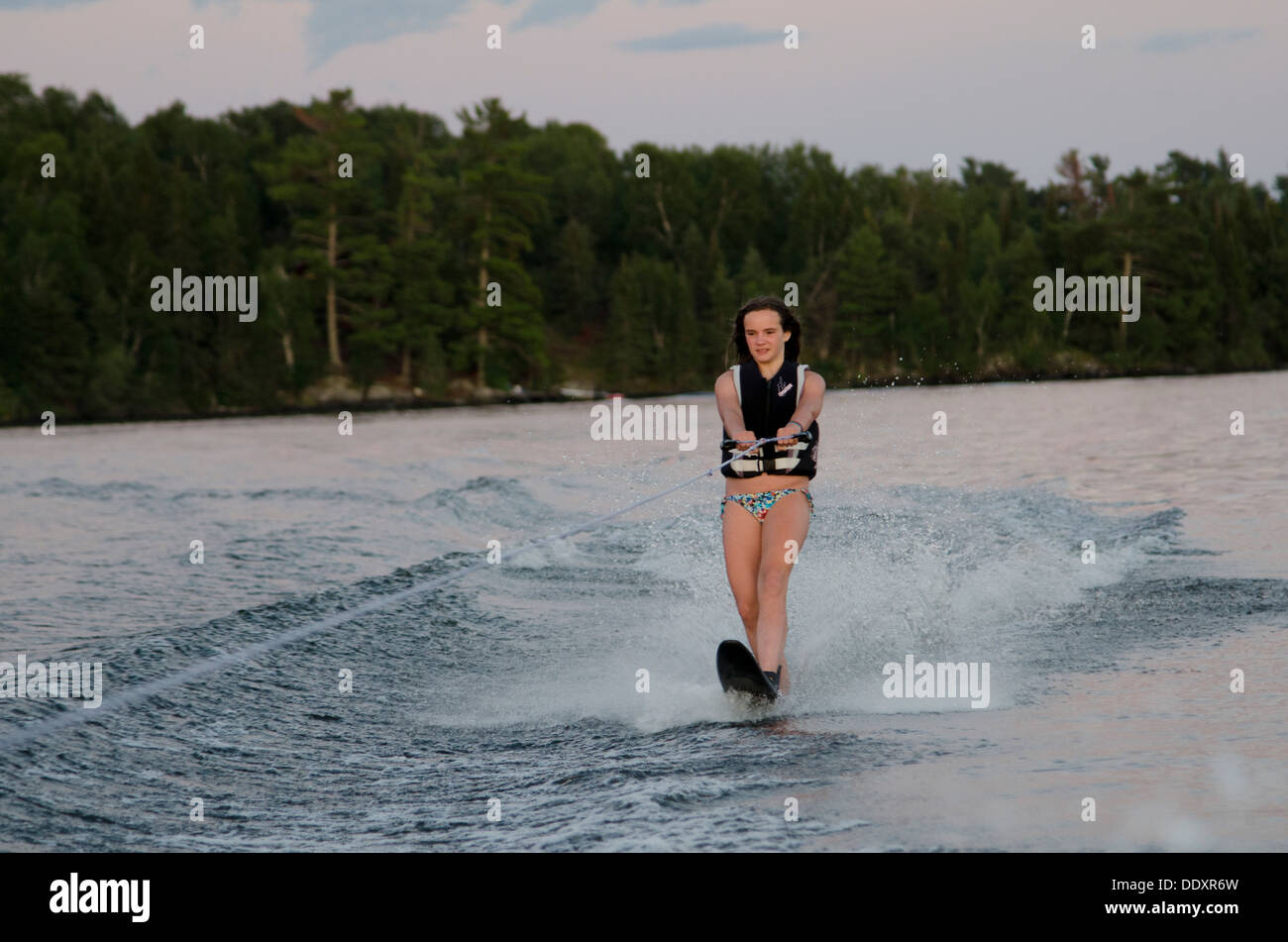 Girl water skiing in a lake, Lake of The Woods, Keewatin, Ontario, Canada Stock Photo