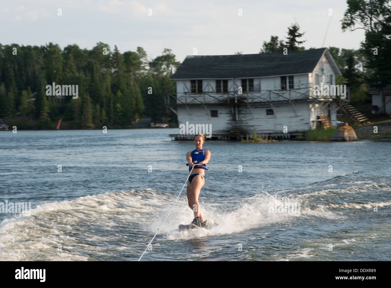 Woman water skiing in a lake, Lake of The Woods, Keewatin, Ontario, Canada Stock Photo