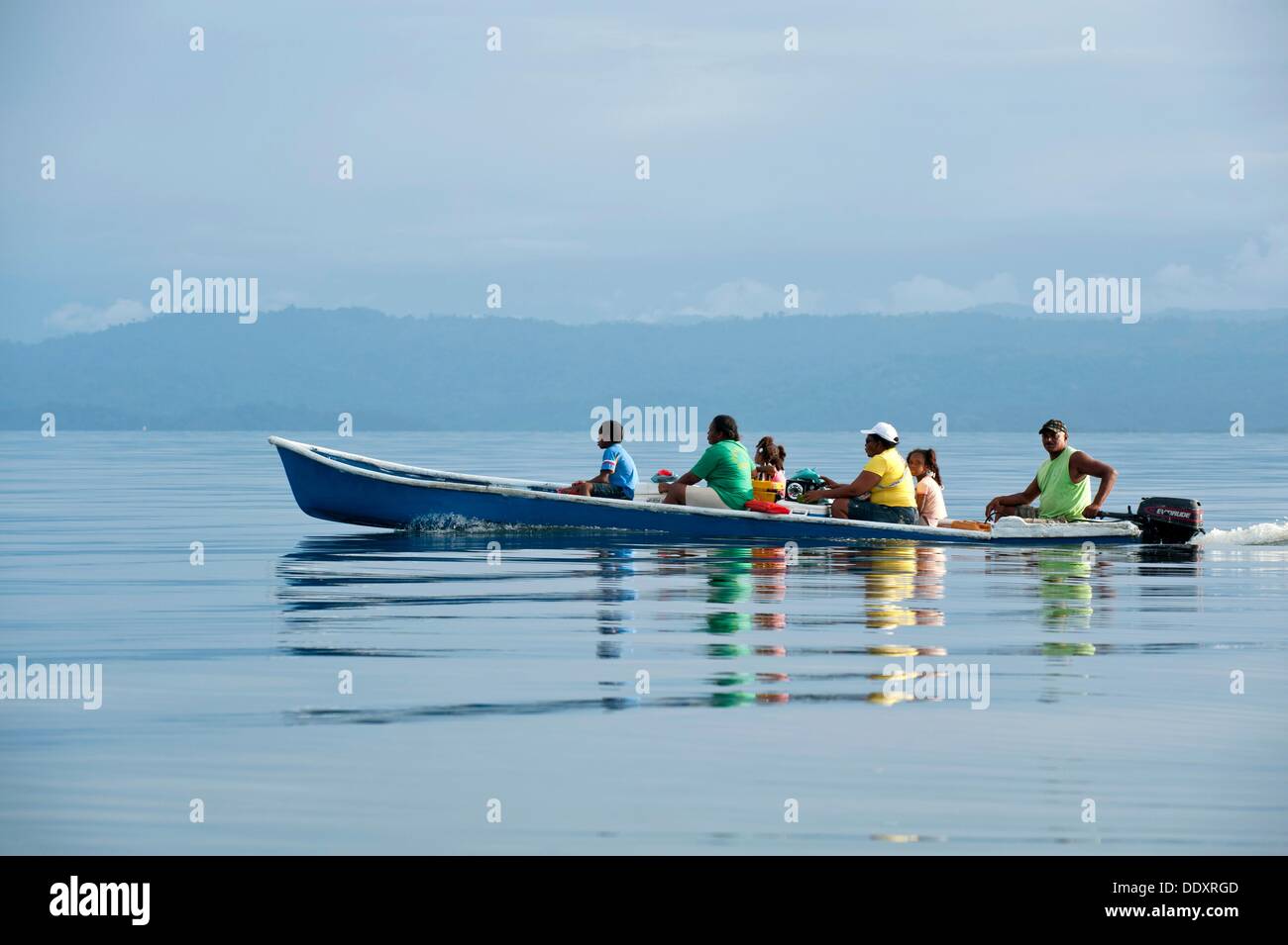 Family traveling in a motorized cayuco boat  Bocas del Toro, Panama, Caribbean, Central America Stock Photo
