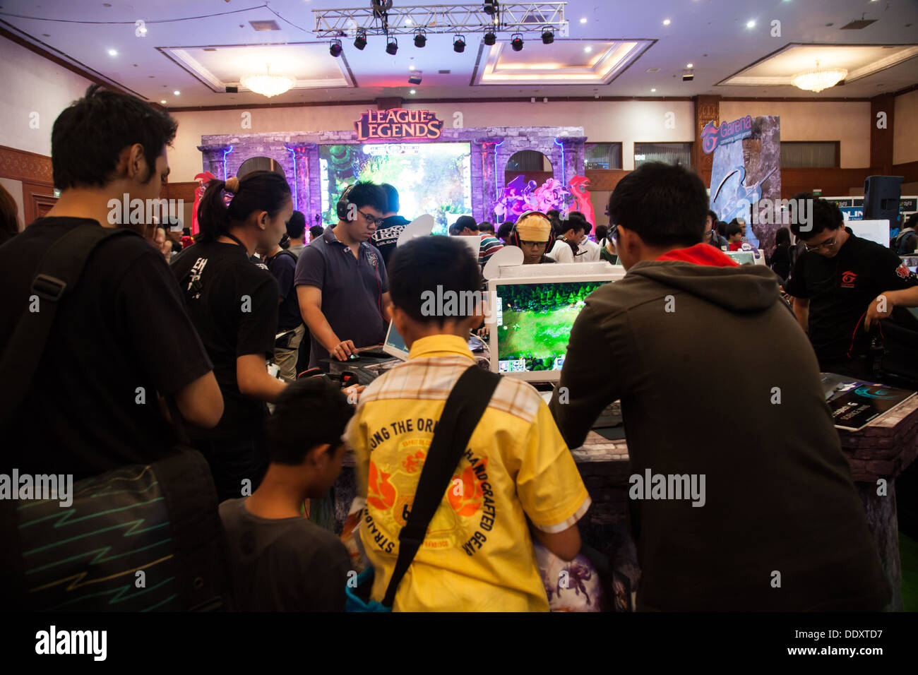 Jakarta, Indonesia, 8th September 2013: Several visitors playing video games on one of the stands at Indo Game Show 2013 event. Stock Photo
