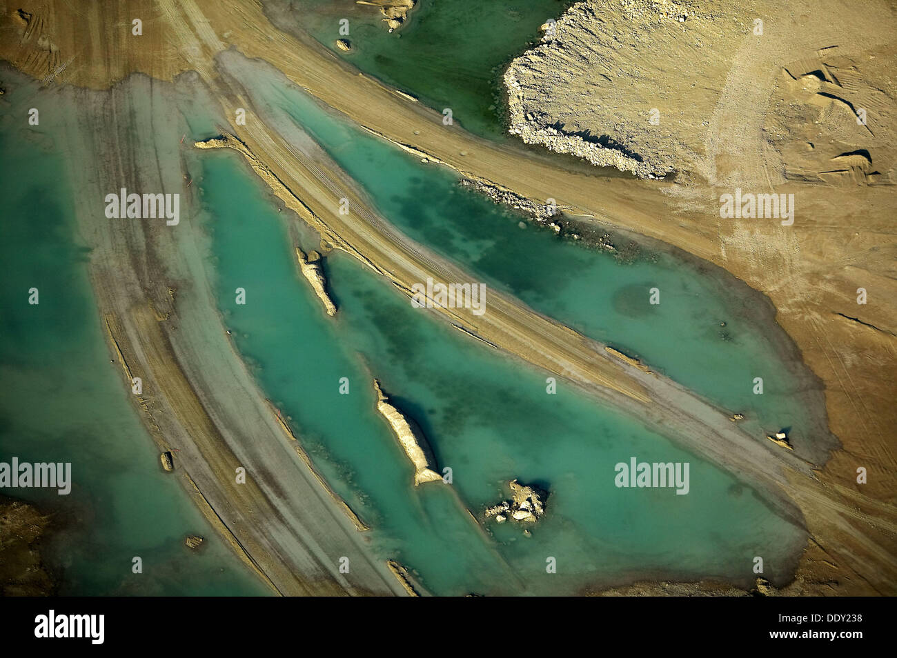 Sand formations in lime stone mine, water, gravel roads, aerial view