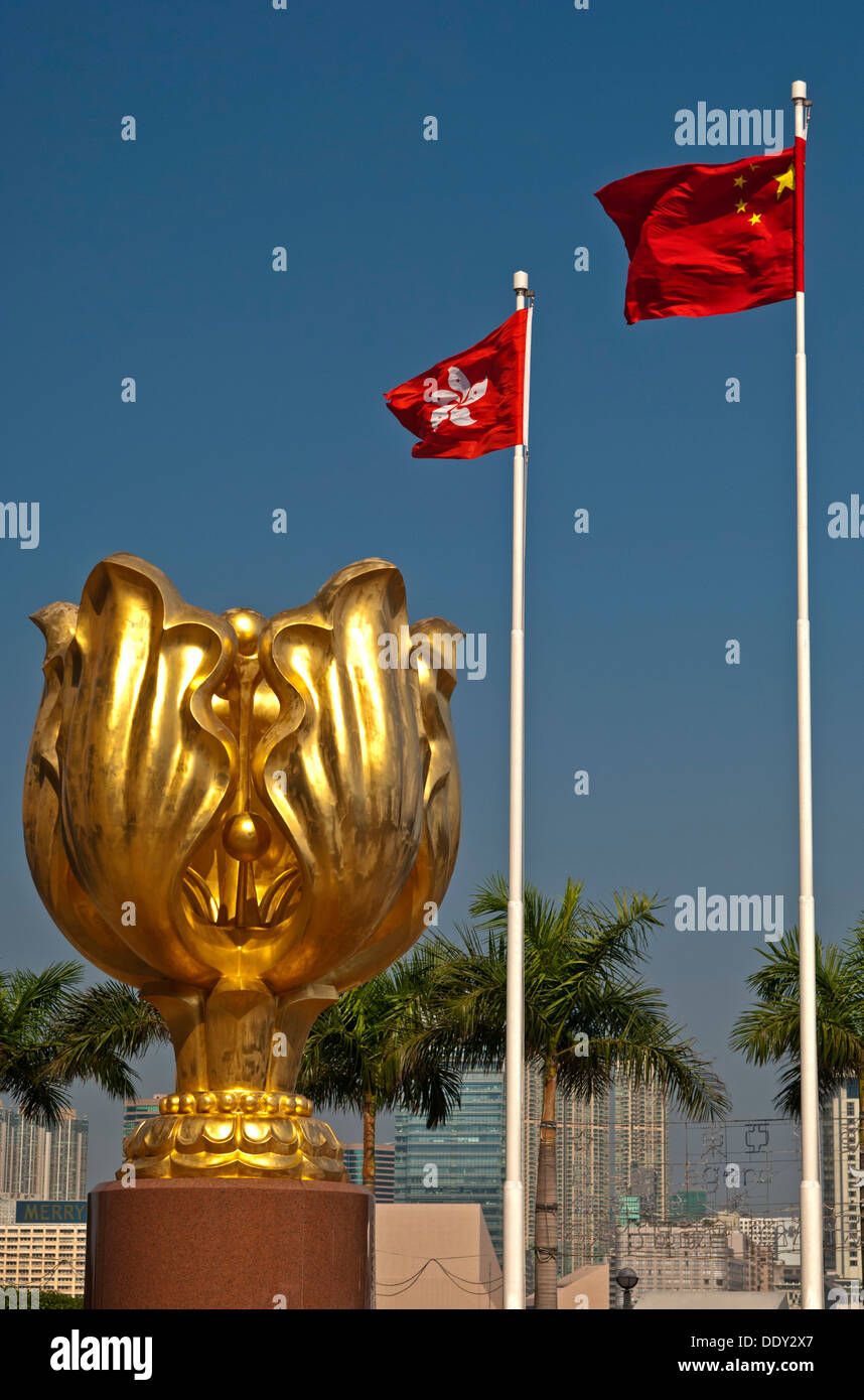 Sculpture of a gilded eternal Bauhinia flower with the flags of Hong