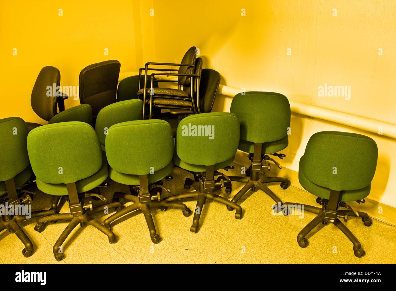 Office chairs stacked in a hallway Stock Photo Alamy