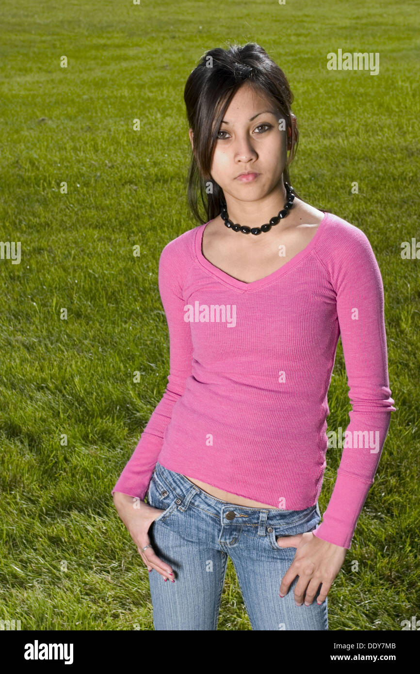 Young Spanish/Asian woman posing at a park Stock Photo Alamy