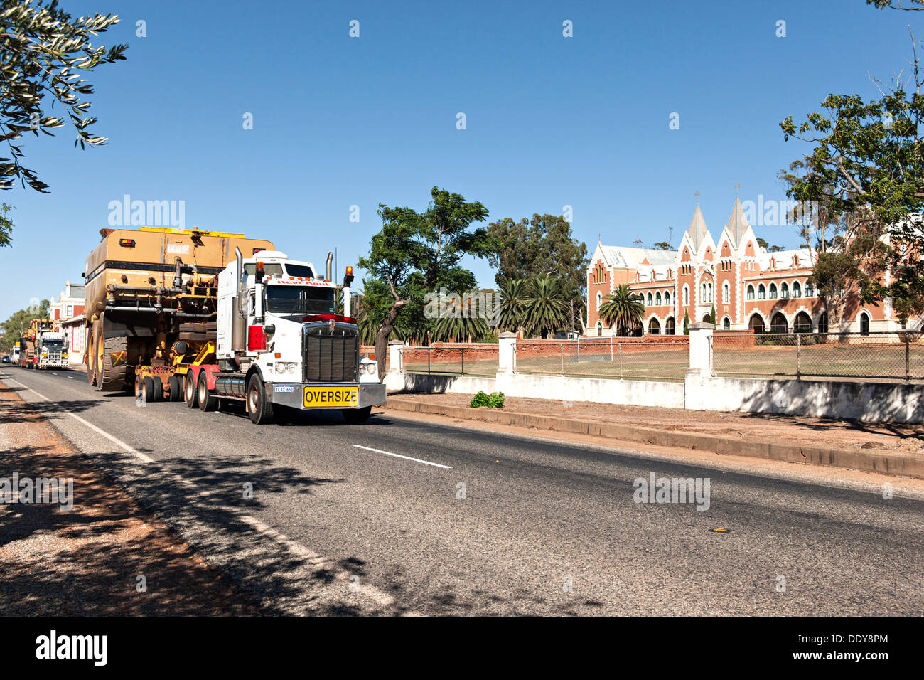 Truck with oversize load passing St IIdephonsus Monastery, New Norcia Western Australia Stock Photo