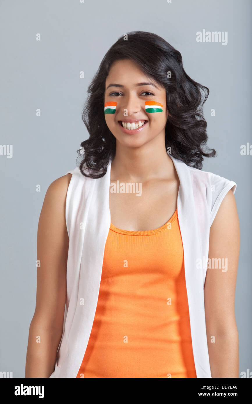 Portrait of happy young woman with face painted in Indian tricolor ...