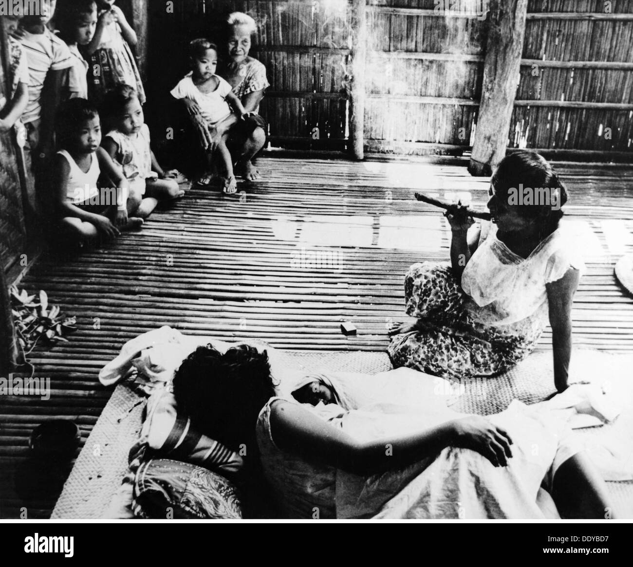 medicine, birth / gynecology, midwife smoking to repel evil spirits fom the hut of a pregnant woman, Escolastica, 1960s, Additional-Rights-Clearences-Not Available Stock Photo
