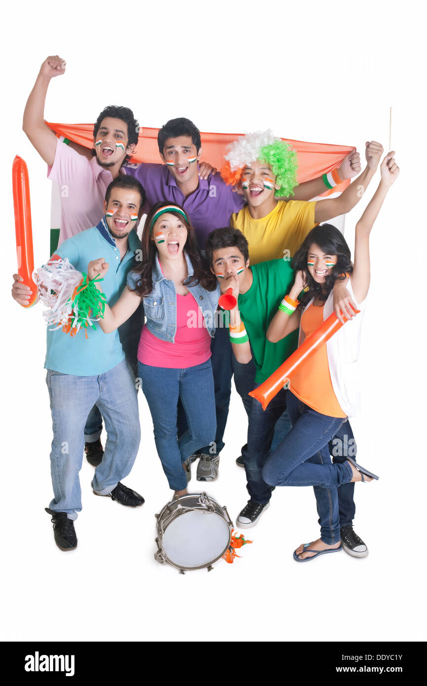 Portrait of exhilarated young friends cheering with Indian flag over white background Stock Photo