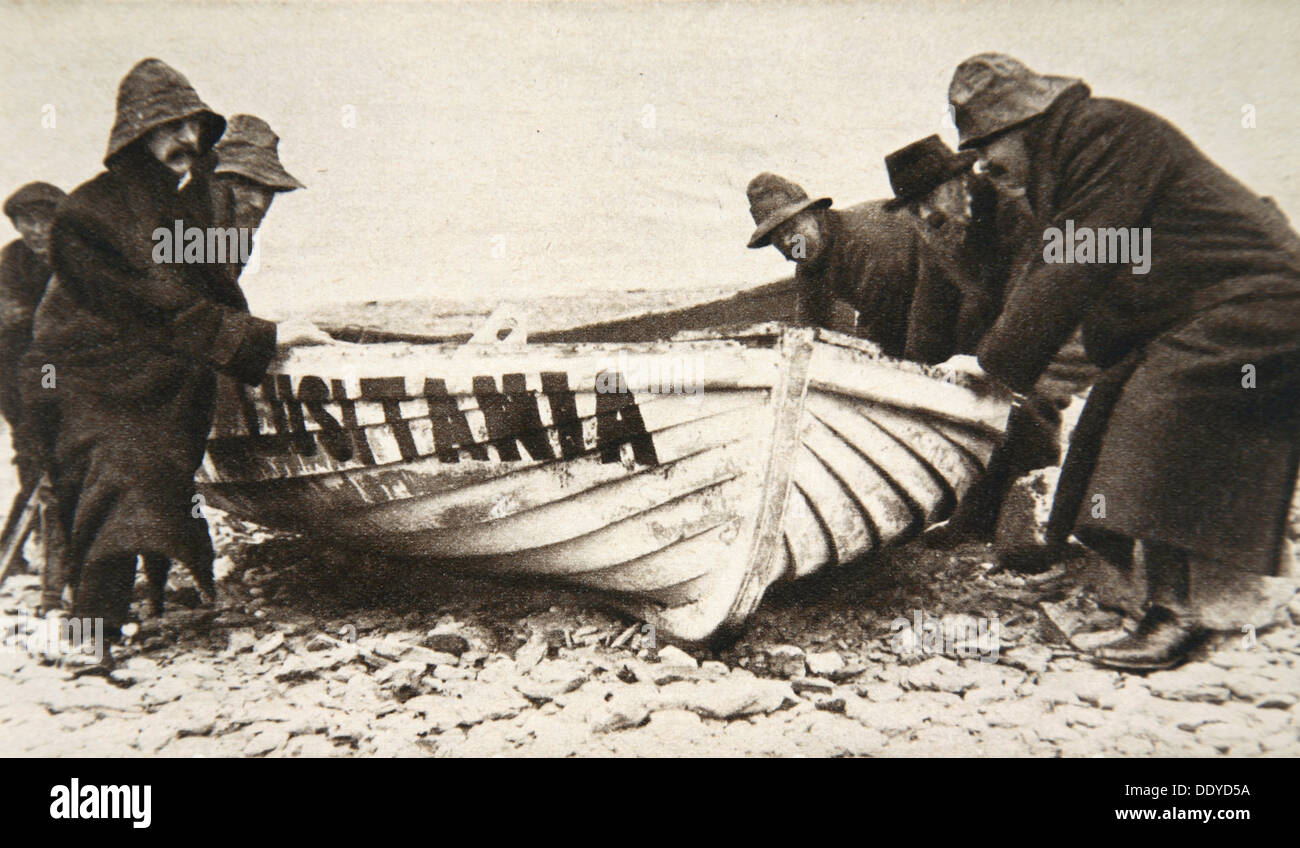 Hauling one of the 'Lusitania's' lifeboats onto the beach, Ireland, 8 May 1915.  Artist: Clarke & Hyde Stock Photo