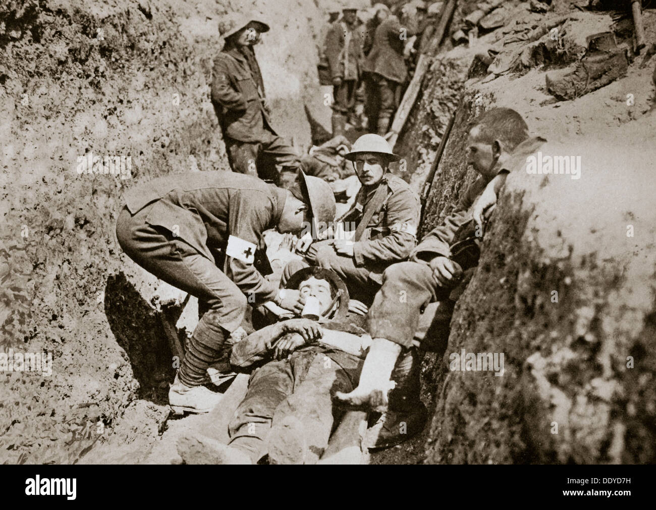 Red Cross men in the trenches tend a wounded man, Somme campaign, France, World War I, 1916. Artist: Unknown Stock Photo