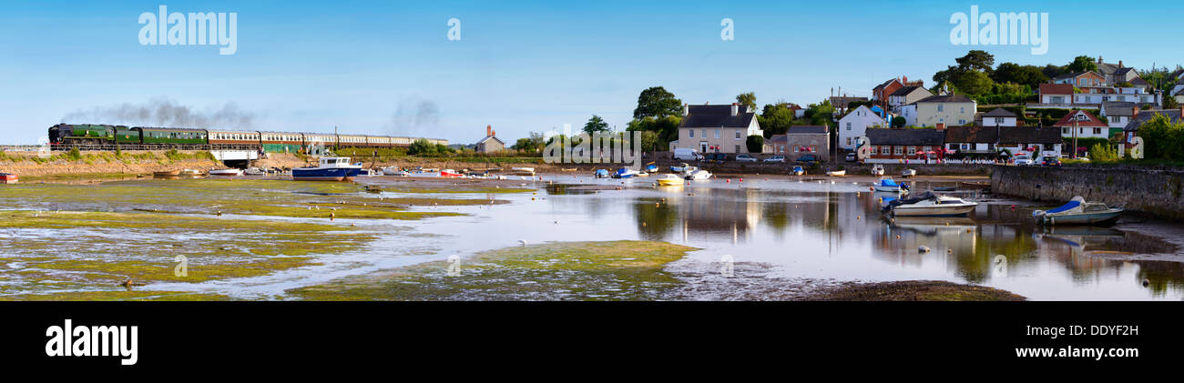 Steam locomotive 34046 Braunton hauls The Torbay Express past Cockwood harbour on its return journey to Bristol. Stock Photo