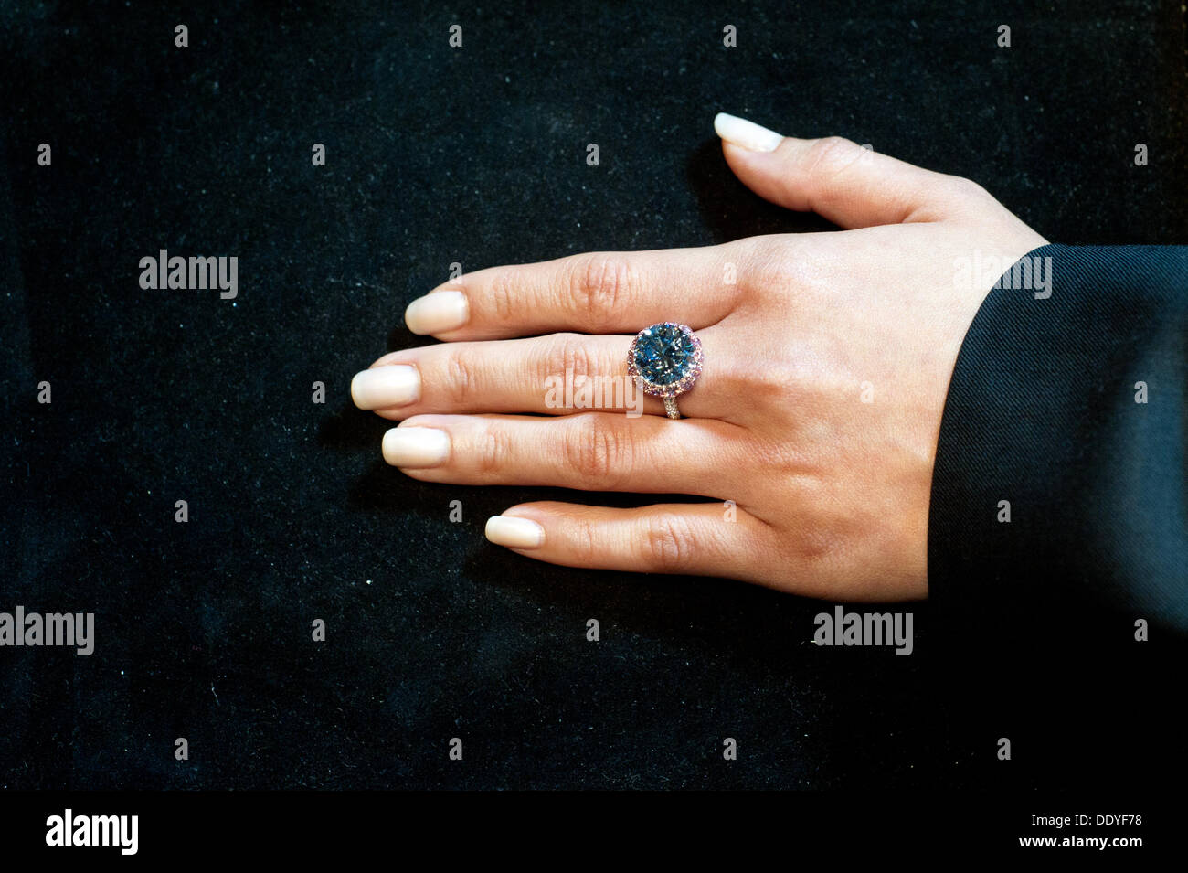London, UK. 9th Sep, 2013.  Sotheby's employee shows a 7.59 Carat Round Brilliant-Cut Internally Flawless Fancy Vivid Blue Diamond (Est. in excess of £12 million), the World’s Largest Round Fancy Vivid Blue Diamond. Credit:  Piero Cruciatti/Alamy Live News Stock Photo