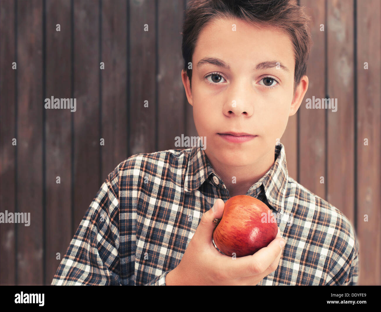 Portrait, boy, teenager eating an apple Stock Photo