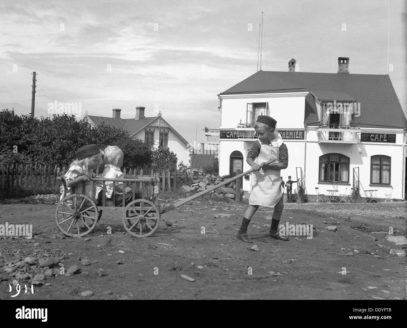 A boy pulling his brother and sister in a cart, 1911. Artist: Unknown ...