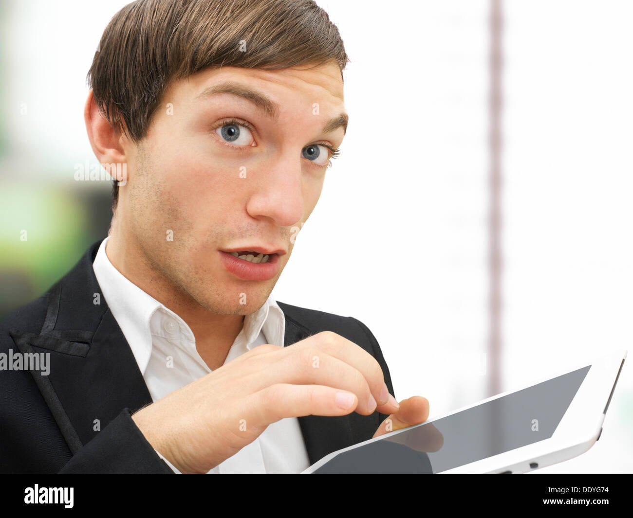 Businessman working on an iPad, focused, stressed, portrait Stock Photo
