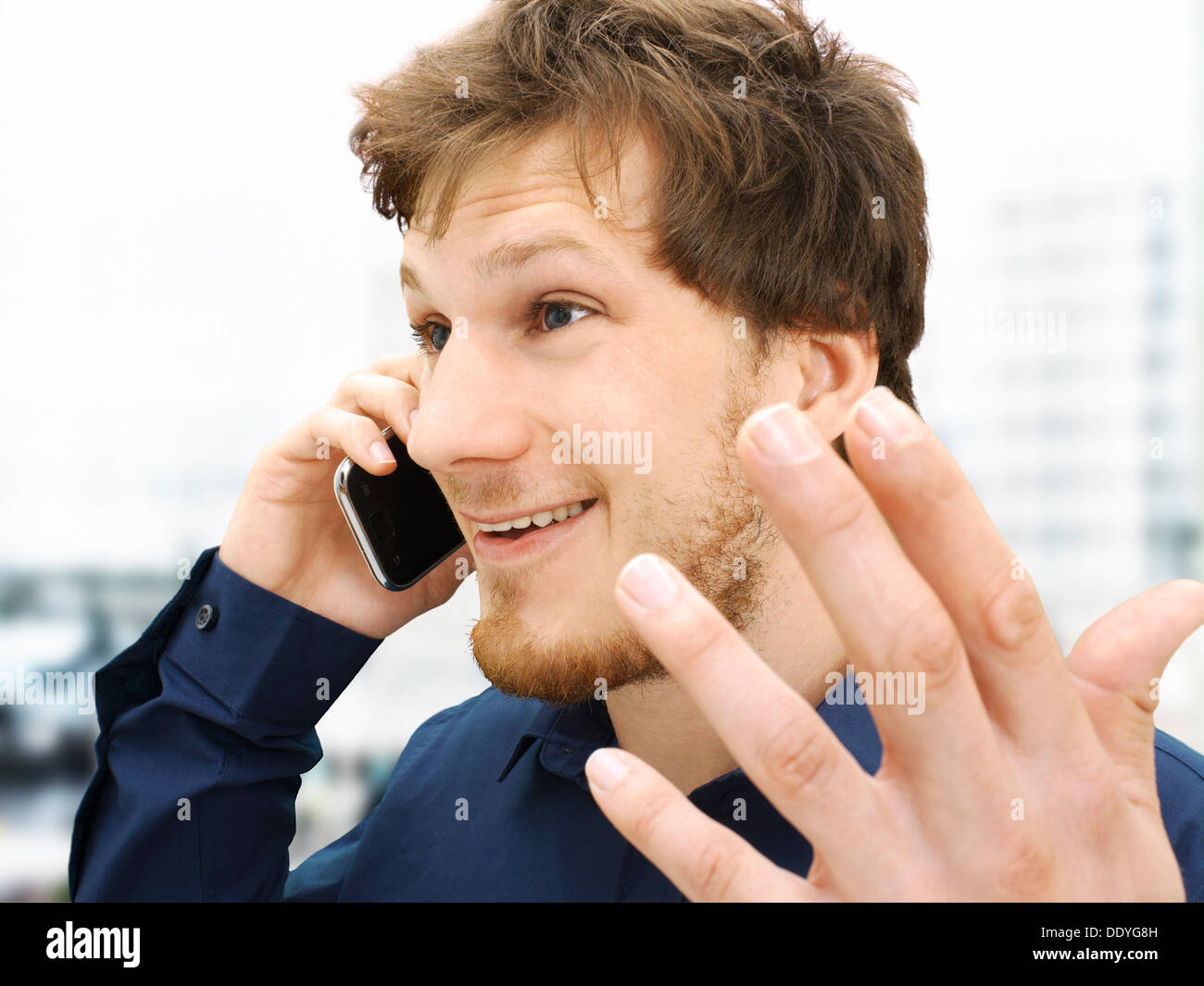 Portrait of a businessman making a telephone call, gesticulating, friendly, optimistic Stock Photo