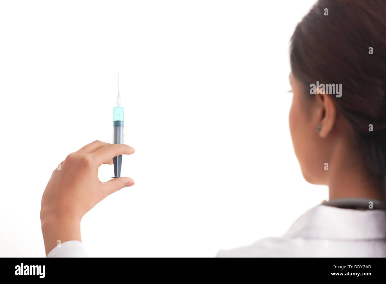 Rear view of a female doctor holding syringe isolated over white ...