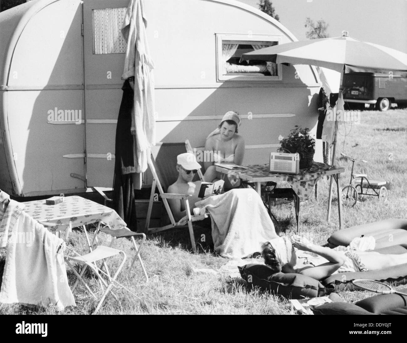 A couple by their caravan at the campsite, Trelleborg, Sweden, 1950s. Artist: Unknown Stock Photo